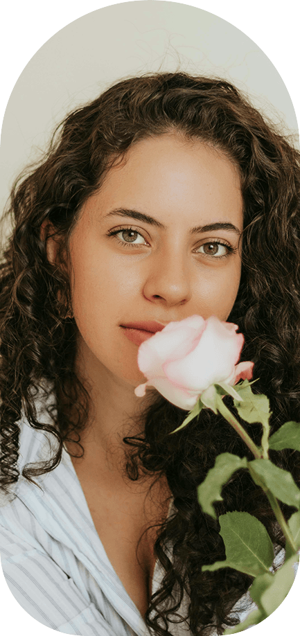 Woman holding a pale rose
